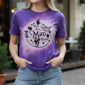NWOT boutique Purple Graphic Tee with 'We're All Mad Here' Design